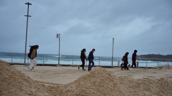 The Bondi promenade covered in sand after severe weather hit Sydney. Picture: NewsWire / Flavio Brancaleone