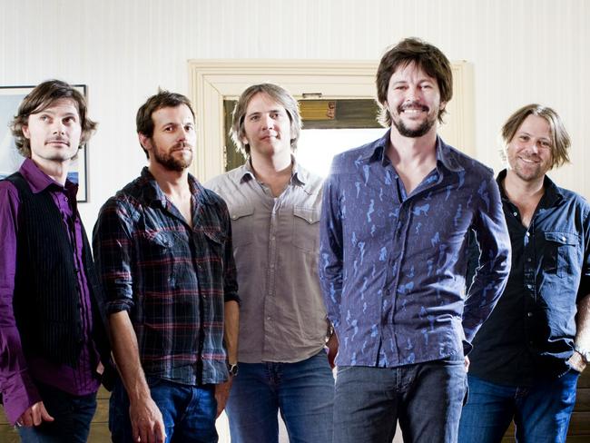 The Powderfinger line-up with Grammar old boys Ian Haug (centre) and John Collins (right).