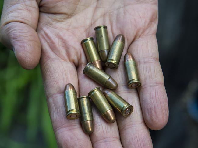 Enzo Condello holding bullets found in the house. Picture: Eugene Hyland