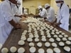 Bolivian soldiers knead dough at an army barracks