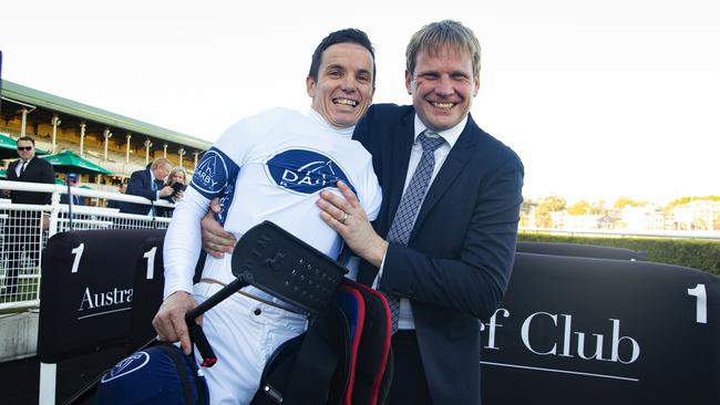 Bjorn Baker hugs jockey Tim Clark after winning the Winx Stakes. Photo: Jenny Evans/Getty Images