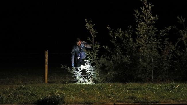 Tasmanian police inspect a property at Magra on Back River Road.  Picture: Zak Simmonds