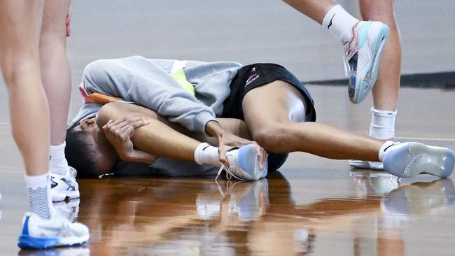 Shamera Stirling of the Thunderbirds lies on the training court in agony after “tweaking” her ankle. Picture: Mark Brake