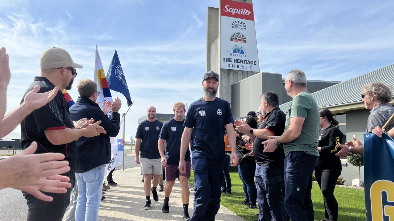 Saputo Dairy Australia Burnie factory workers walking off the site as a guard of honour is formed by union members. Picture: Simon McGuire.