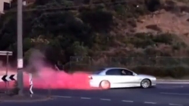 Coloured smoke can be seen coming from a hoon’s car near Frankston.