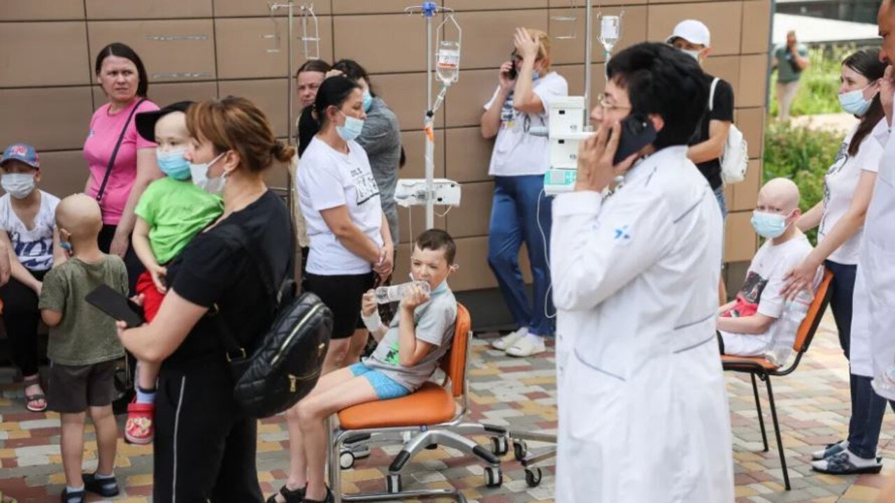 Young cancer patients sit with their parents and doctors after the attack. Credit: Reuters