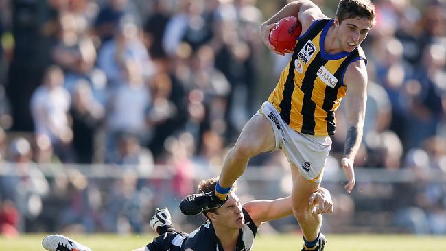 MELBOURNE, AUSTRALIA - AUGUST 30: Dylan Weickhardt of Sandringham evades a tackle during the VFL Elimination Final match between Collingwood and Sandringham at Victoria Park on August 30, 2014 in Melbourne, Australia. (Photo by Darrian Traynor/Getty Images)