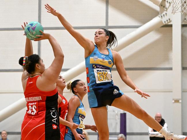 Jess Milne of the Titans defends over Cougars goal shooterLarika Malagaoma. Picture: Chloe Davis