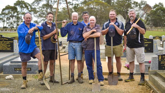 Digging deep: Brandan Wardle, Duane Dudgeon, Kevin Teague, Brett Garner, Colin Barrett, Katandra, Corey Wilson and Ian White are among members of the Katandra Football Club who help dig graves at the Katandra Cemetary as a service offered to the community.