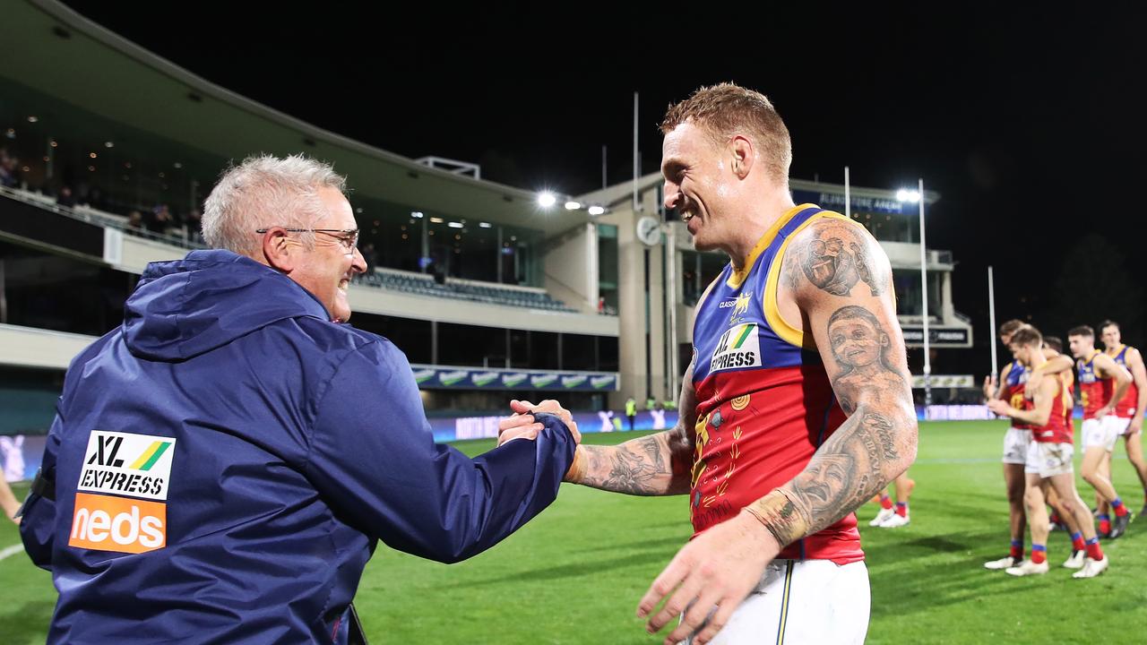 HOBART, AUSTRALIA – JUNE 19: Mitch Robinson of the Lions and Lions head coach Chris Fagan celebrate victory after the round 14 AFL match between the North Melbourne Kangaroos and the Brisbane Lions at Blundstone Arena on June 19, 2021 in Hobart, Australia. (Photo by Matt King/AFL Photos/via Getty Images)