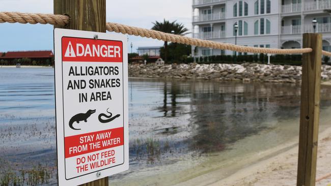 FILE - In this Friday, June, 17, 2016 file photo released by Walt Disney World Resort, a new sign is seen posted on a beach outside a hotel at a Walt Disney World resort in Lake Buena Vista, Fla., after a 2-year-old Nebraska boy killed by an alligator at Disney World. Matt Graves, the father of the toddler killed by an alligator at Disney on June 14, told rescue officials two alligators were involved in the attack, according to emails from the Reedy Creek Fire Department. (Walt Disney World Resort via AP, File)