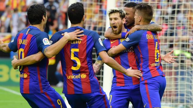 Barcelona's Argentinian forward Lionel Messi (C) celebrates a goal.
