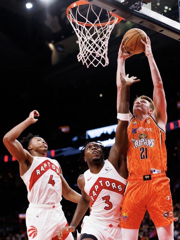 O.G. Anunoby #3 and Scottie Barnes #4 of the Toronto Raptors try to block a shot by Sam Waardenburg of the Cairns Taipans. Picture: Cole Burston/Getty Images