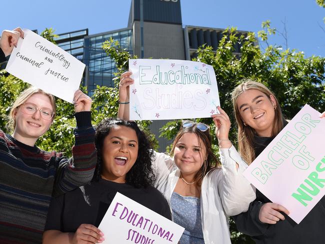 (L-R) Shelby Dedman, Makayla Hudson, Caitlyn Legg and Lucinda Stephens have had early offers from Australian Catholic University holding up signs saying what they got in to. Picture: Josie Hayden