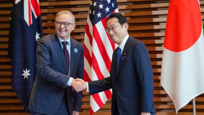 Japanese Prime Minister Fumio Kishida, right, welcomes Australian Prime Minister Anthony Albanese, left, at the premier office in Tokyo on May 24, 2022. (Photo by ZHANG Xiaoyu / various sources / AFP)