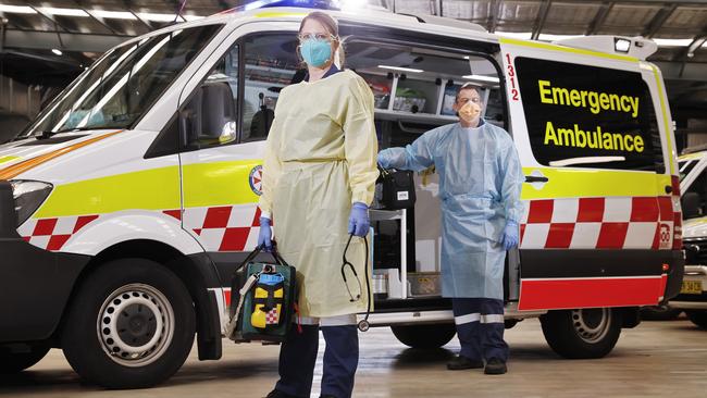 Naomi Batten (left) and Jason Ryan don their PPE to start their shift. Picture: Sam Ruttyn