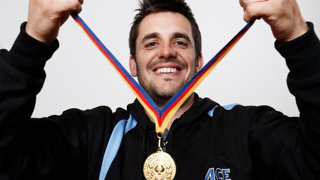 Modbury Football Club legend Tim Davey with one of his many medals. Picture: Matt Loxton