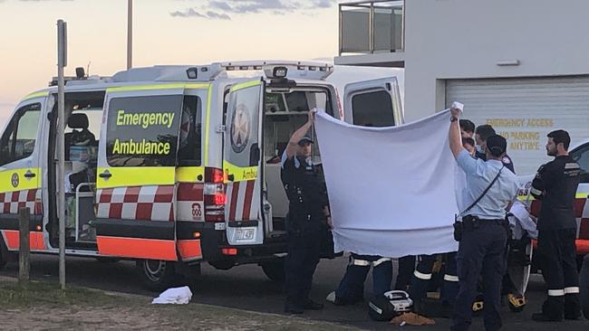 Emergency services work to stabilise a man who suffered suspected spinal injuries in the ocean pool at Sydney's Dee Why Beach on Thursday night. Picture: Manly Daily