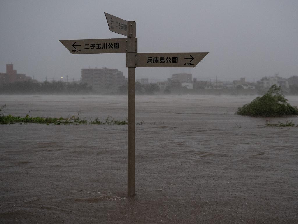 A sign is partially submerged as the Tama River floods during Typhoon Hagibis. Picture: Getty