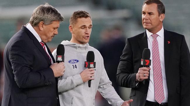 Joel Selwood of the Cats speaks to Channel 7 commentators Brian Taylor (left) and Wayne Carey during a match last year. Picture: AAP