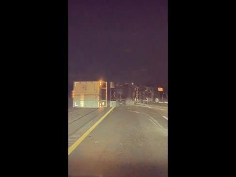 Drivers dodge toppling semi-trailer knocked over by the wind