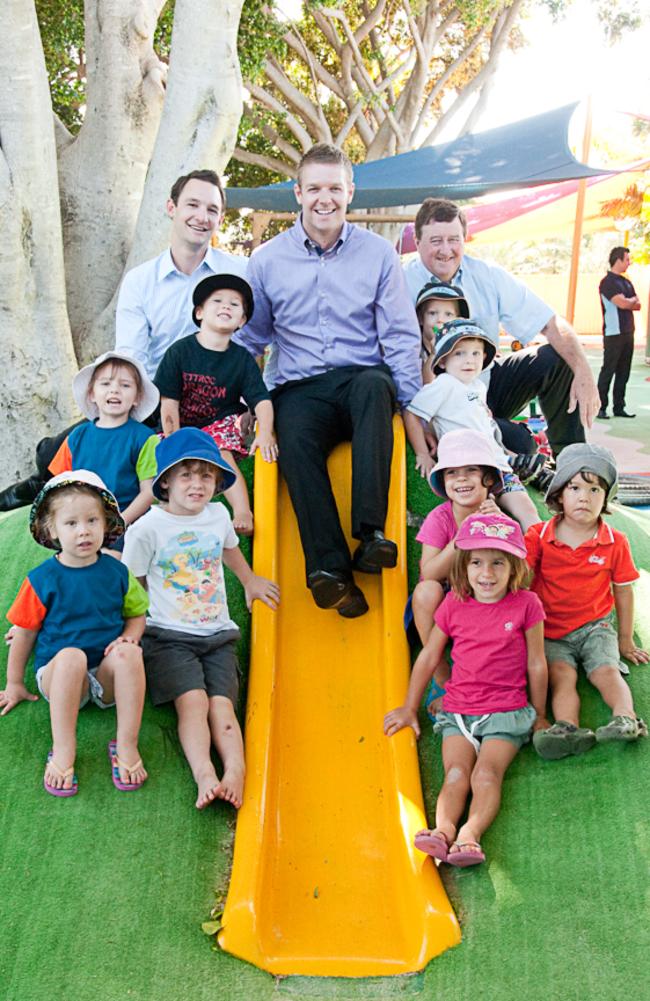 G8 Education's management team Chris Sacre (from left), Jae Fraser and Chris Scott with kids at a childcare centre.