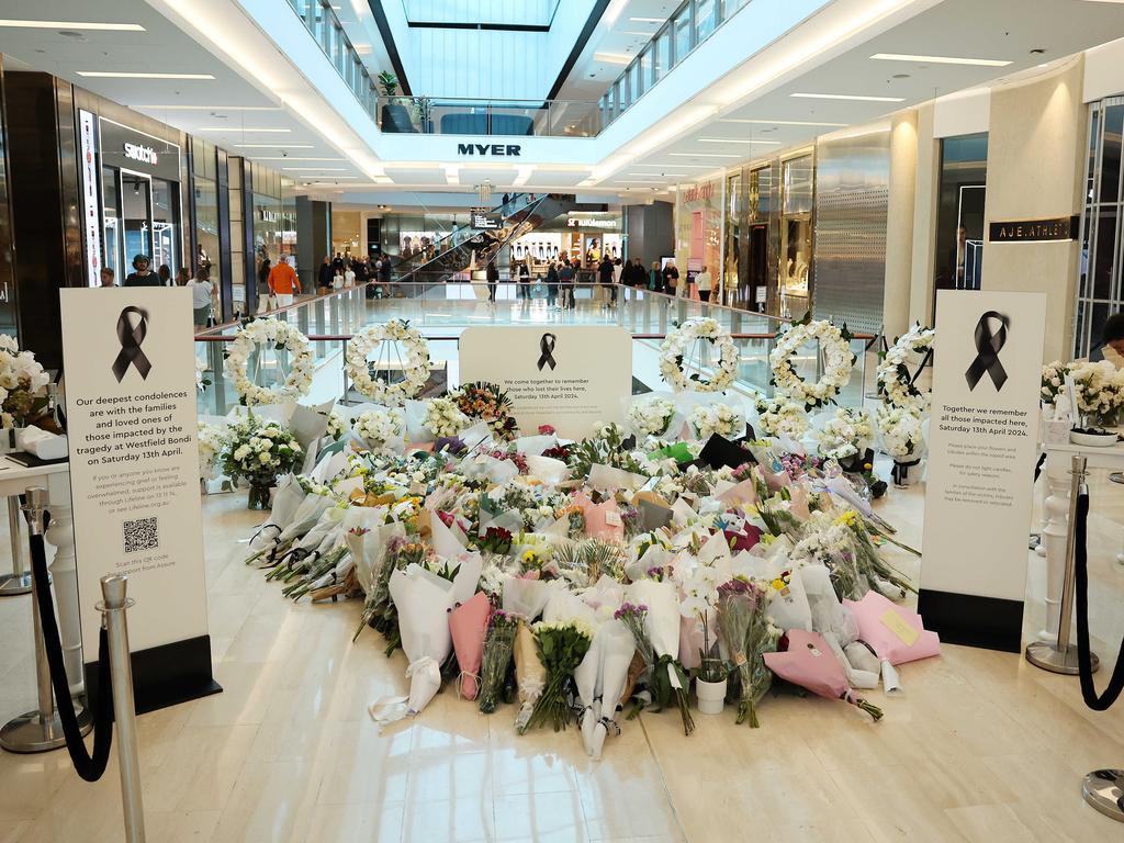 People gather for a flower tribute inside the Westfield Shopping Centre in Bondi Junction, marking one week since the tragic stabbing incident last Saturday. Picture: Tim Hunter