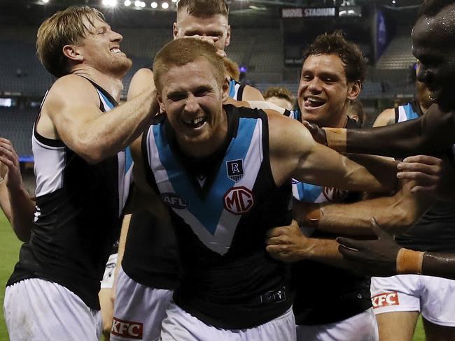 MELBOURNE, AUSTRALIA - MARCH 21: Tom Clurey of the Power leads the Power off the field after a win in the 2021 AFL Round 01 match between the North Melbourne Kangaroos and the Port Adelaide Power at Marvel Stadium on March 21, 2021 in Melbourne, Australia. (Photo by Dylan Burns/AFL Photos via Getty Images)