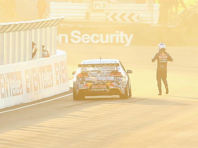 BATHURST, AUSTRALIA - OCTOBER 12:  Jamie Whincup walks away from the #1 Red Bull Racing Australia Holden after running out of fuel on the last lap during the Bathurst 1000, which is round 11 and race 30 of the V8 Supercars Championship Series at Mount Panorama on October 12, 2014 in Bathurst, Australia.  (Photo by Mark Kolbe/Getty Images)