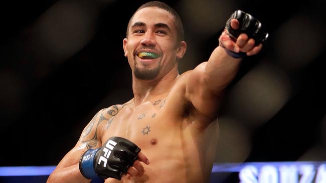 Robert Whittaker celebrates after defeating Jacare Souza.