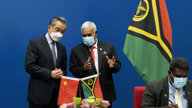 Vanuatu's Prime Minister Bob Loughman Weibur (C) with Chinese Foreign Minister Wang Yi (L) during a signing ceremony of agreements between the two countries. Picture: AFP.