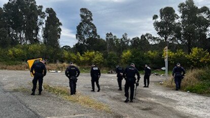 Police search an area near the intersection of Wakefield and Sugarloaf Range roads on August 11, 2022 as part of an investigation into the kneecapping of a Nomads bikie nominee.