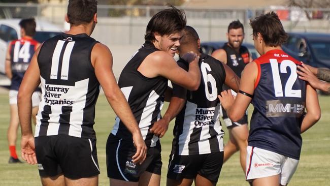 Josh Carmichael and Jimmy Kennedy after Kennedy kicks a goal for Merbein in their win over Mildura in Sunraysia football. Picture: Michael DiFabrizio