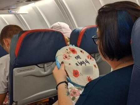 The woman was photographed sewing the message on board the plane.