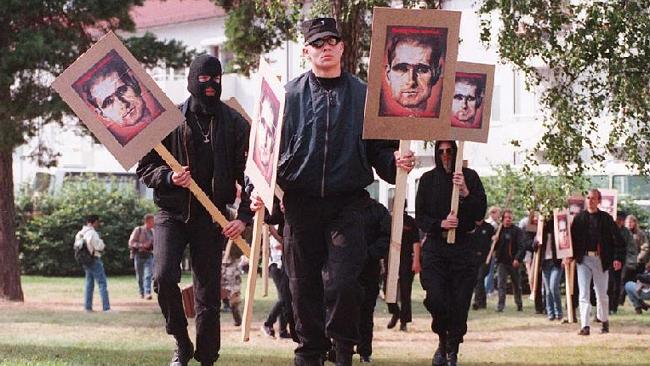 Neo-Nazis carry placards bearing portrait of Hitler's deputy Rudolph Hess in Trollhattan, Sweden, in 1996, to mark the annive...