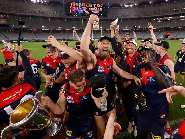 Melbourne players celebrate on their lap of honour. Picture: Michael Willson/AFL Photos via Getty Images