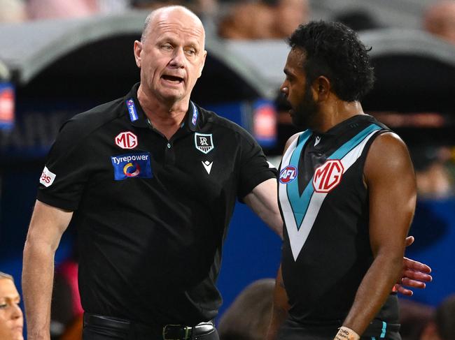 ADELAIDE, AUSTRALIA - APRIL 13: Ken Hinkley, Senior Coach of the Power speaks to Willie Rioli of the Power during the round five AFL match between Port Adelaide Power and Hawthorn Hawks at Adelaide Oval, on April 13, 2025, in Adelaide, Australia. (Photo by Quinn Rooney/Getty Images)