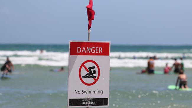 Mobile phone safety messages or old school signage? Which is the best way to get a message out on our beaches. Picture by Scott Fletcher.