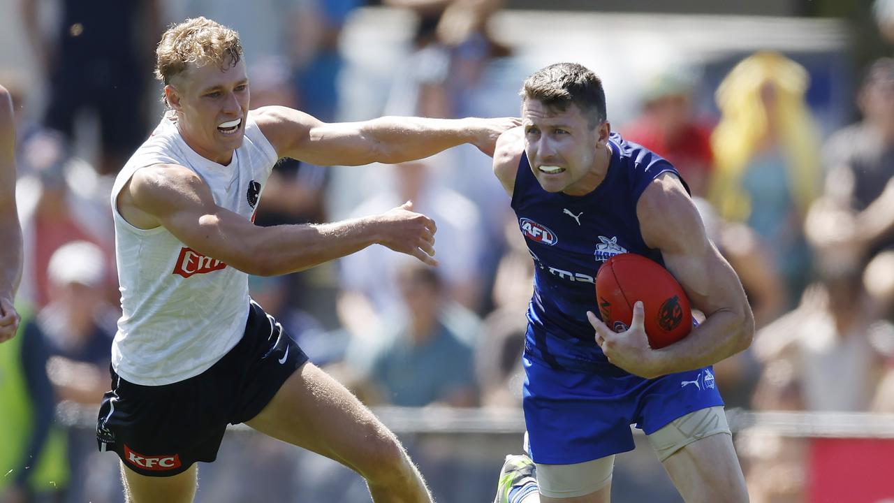 Liam Shiels of the Kangaroos brushes past Finlay Macrae of the Magpies. Picture: Michael Klein