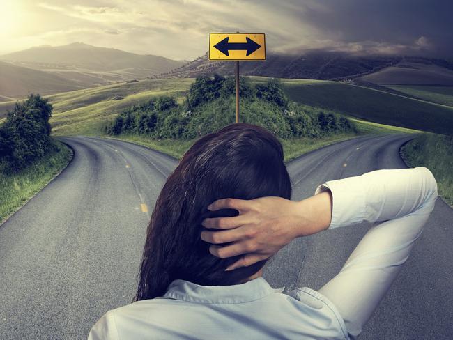 business woman in front of two roads thinking deciding hoping for best taking chance