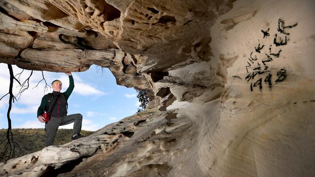 Climber Mark Wood at an area damaged by graffiti at Beehive Falls in the Grampians. Picture: David Geraghty