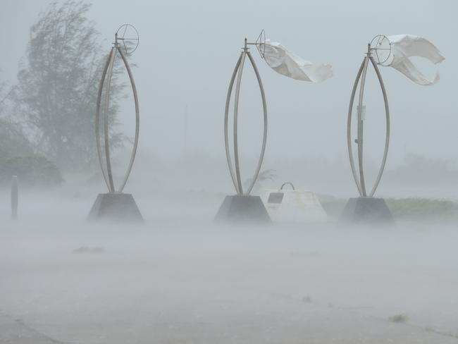 28/3/17: the foreshore wind socks are now destroyed by the continuing wind as Bowen continues to feel the effects of driving rain. Picture: Lyndon Mechielsen/The Australian