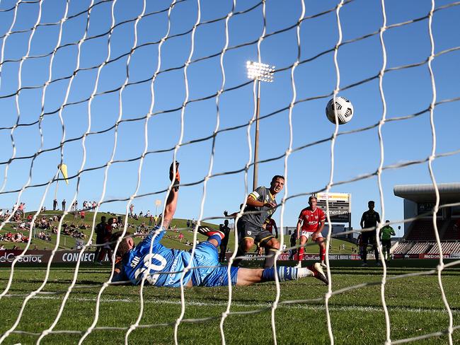 WOLLONGONG, AUSTRALIA - MARCH 28: Denis Genreau of Macarthur FC scores his teams first goal past Oliver Sail of the Phoenix during the A-League match between Wellington Phoenix and Macarthur FC at WIN Stadium, on March 28, 2021, in Wollongong, Australia. (Photo by Ryan Pierse/Getty Images)