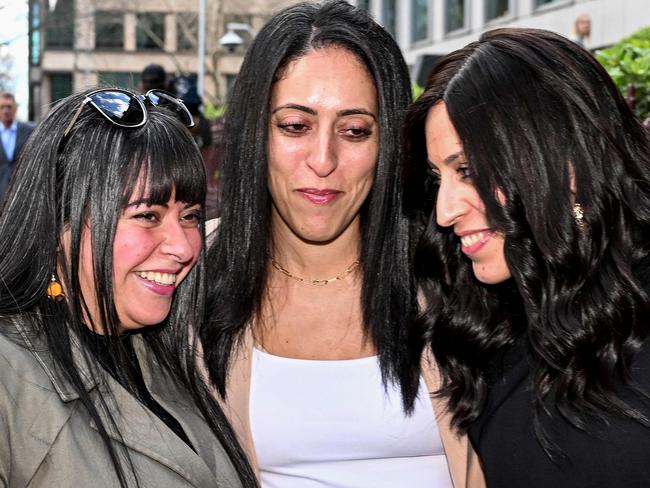 Sisters Dassi Erlich (L), Elly Sapper (C) and Nicole Meyer embrace outside the County Court in Melbourne on August 24, 2023, after ex-headmistress Malka Leifer was sentenced to 15 years in jail for sexually abusing Dassi and Elly at an Australian Jewish school, before fleeing to Israel then being extradited back. (Photo by William WEST / AFP)