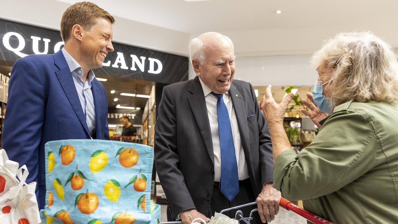 Former Australian Prime Minister John Howard speaks with Bernice Janz (right) on the campaign trail with the Member for Ryan, Julian Simmonds (left). NewsWire / Sarah Marshall