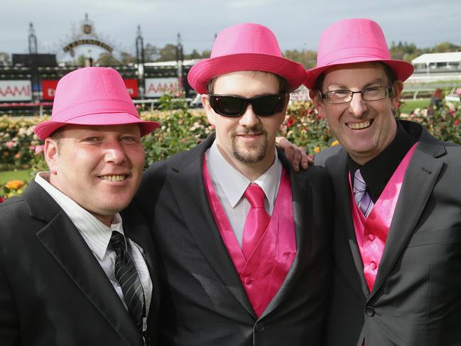 Mathew Gammon, Chris Fellows and David Lacy in pink hats on Victoria Derby Day at Flemington Racecourse on Saturday, November 1, 2014, in Flemington, Australia. Picture: Hamish Blair