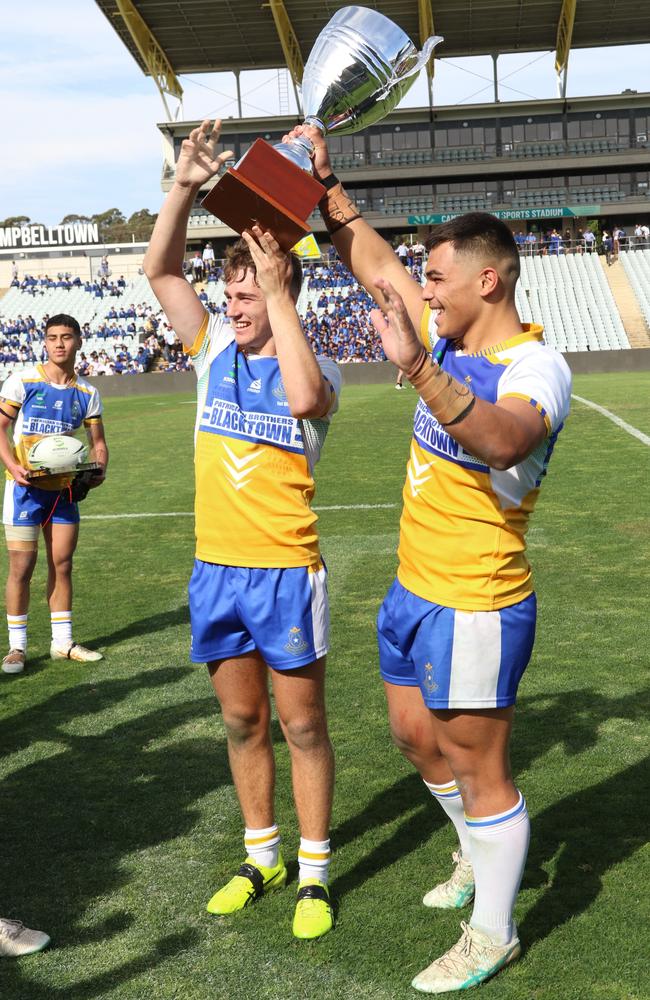 Patrician Brothers captains Jared Haywood and Jacob Halangahu lift the Peter Mulholland Cup after the grand final between Patrician Brothers Blacktown and Endeavour Sports High. Picture: Warren Gannon Photography