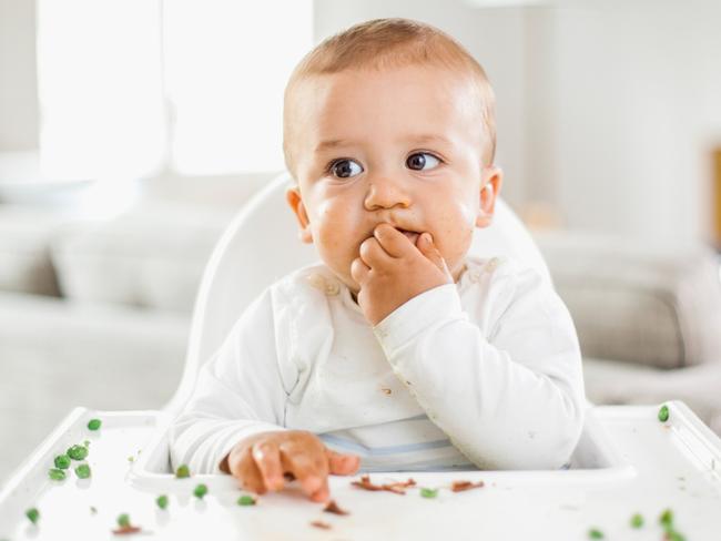 Fussy kid toddler eating food, istock.