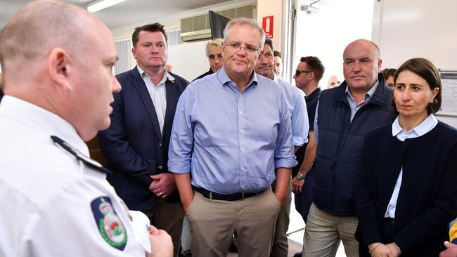 NSW Rural Fire Service Commissioner Shane Fitzsimmons briefs Scott Morrison and NSW Premier Gladys Berejiklian at the Wollondilly Emergency Control Centre in Sydney on Sunday. Picture: AAP