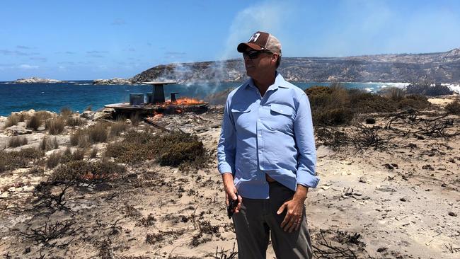 James Baillie in front of a burning table a couple of days after the fire destroyed the iconic Southern Ocean Lodge in January 2020. Photo: Supplied